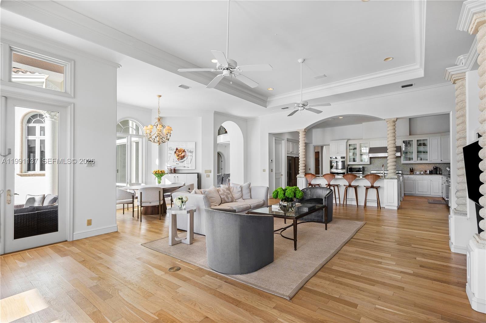 4900 Sanctuary Lane Boca Raton, FL 33431 - Photo 12 of 64 a living room with furniture wooden floor and a view of kitchen