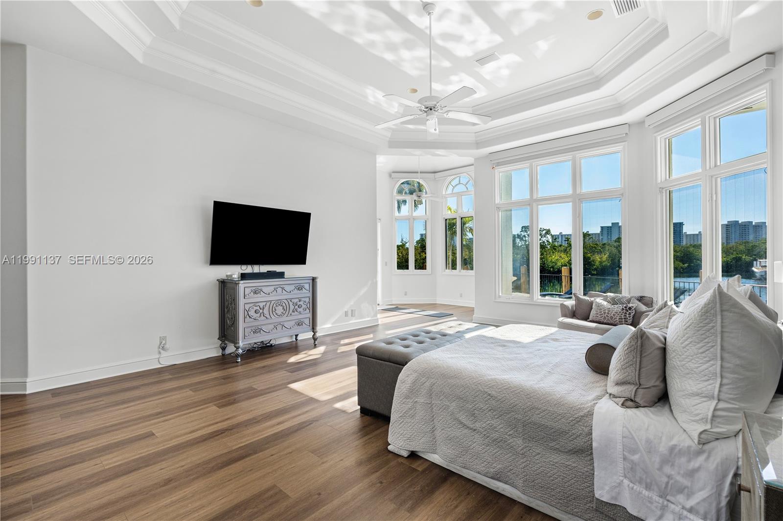 4900 Sanctuary Lane Boca Raton, FL 33431 - Photo 19 of 64 a spacious bedroom with a bed and a flat screen tv