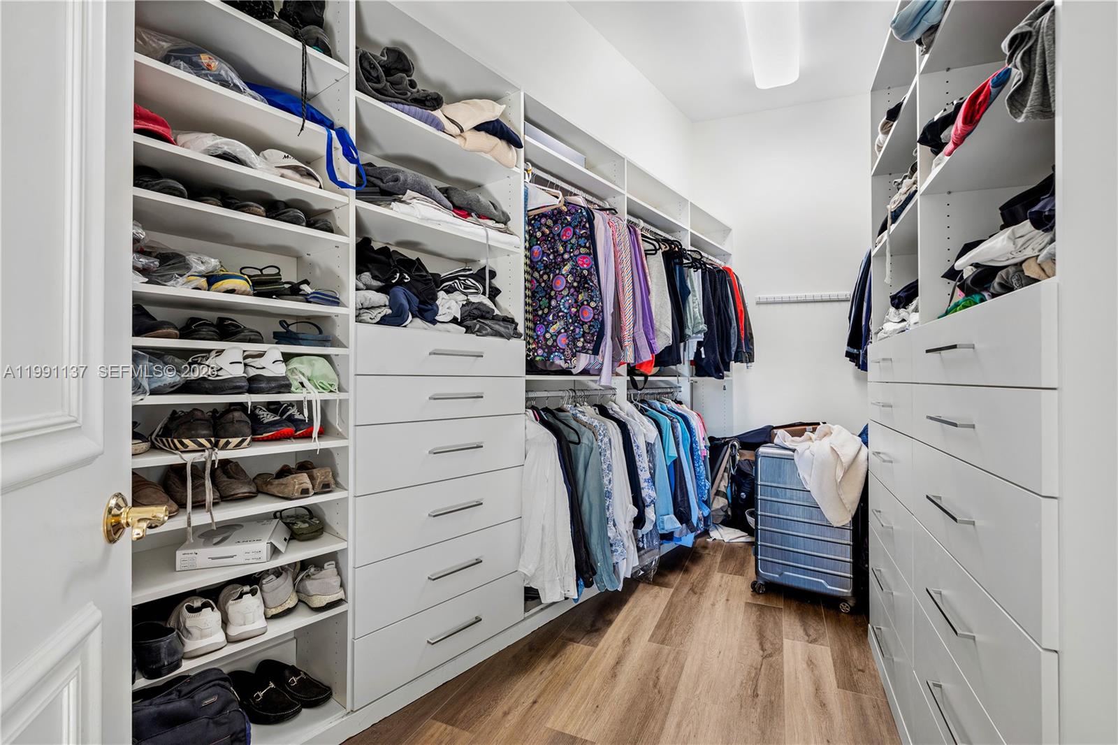 4900 Sanctuary Lane Boca Raton, FL 33431 - Photo 24 of 64 a view of walk in closet with clothes and shoes