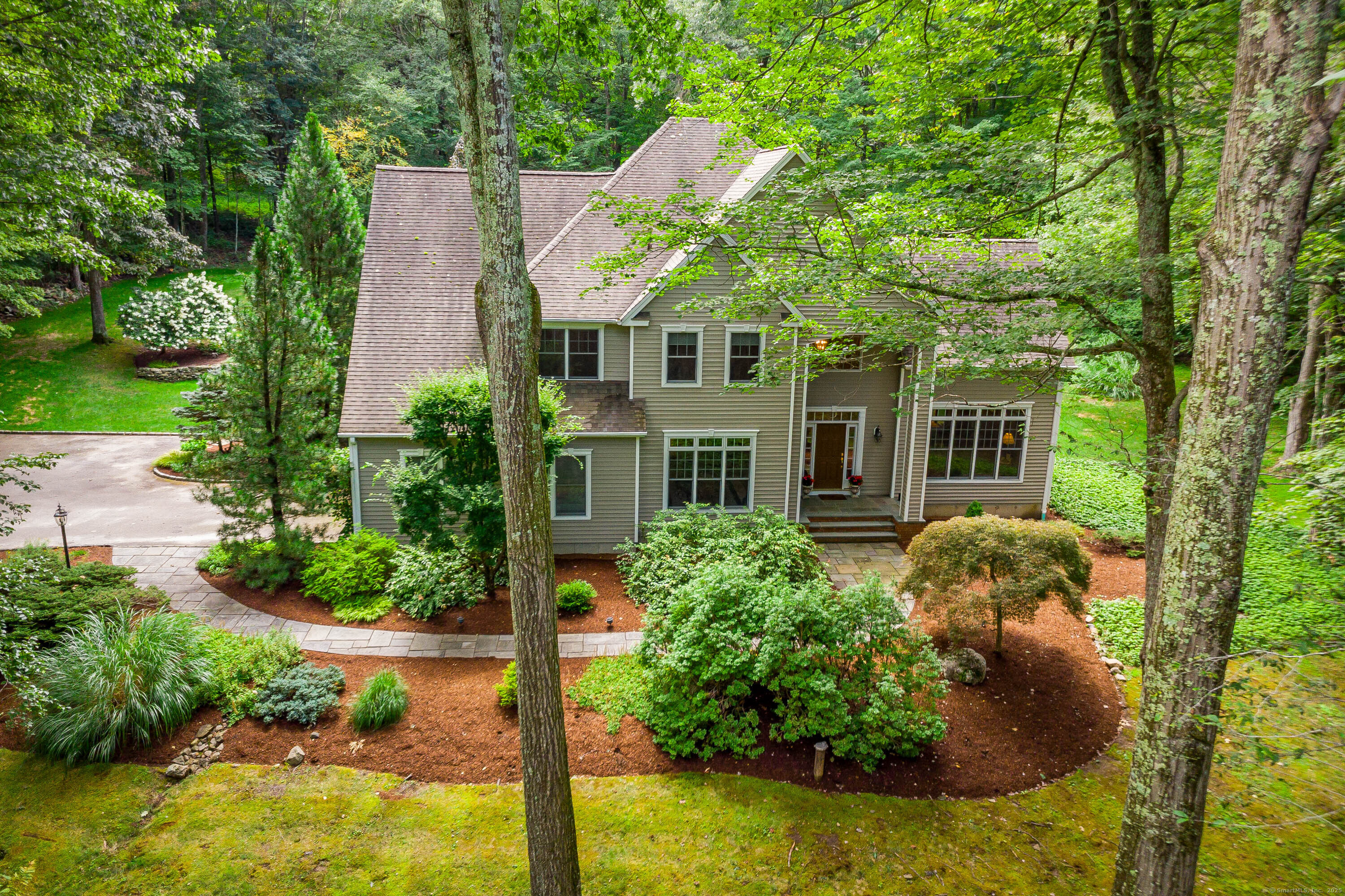 a view of a house with pool and garden