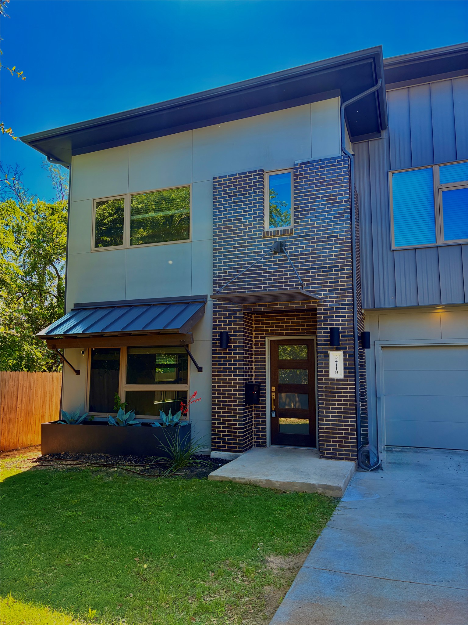 3411 Willow Springs Road, Unit B Austin, TX 78704 - Photo 1 of 8 a view of a house with a small yard and a fireplace
