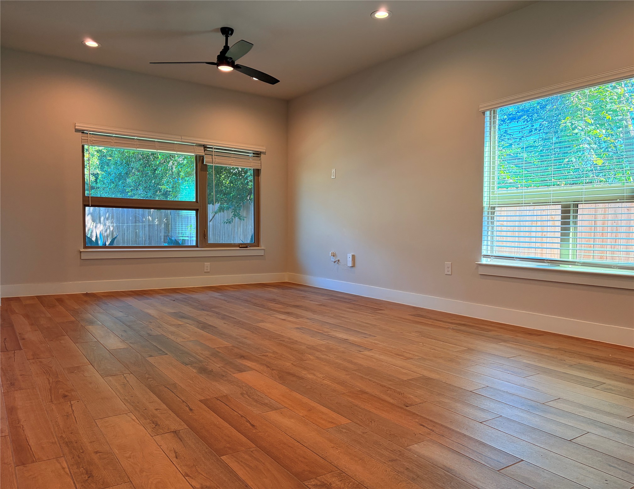 3411 Willow Springs Road, Unit B Austin, TX 78704 - Photo 2 of 8 an empty room with wooden floor chandelier and windows