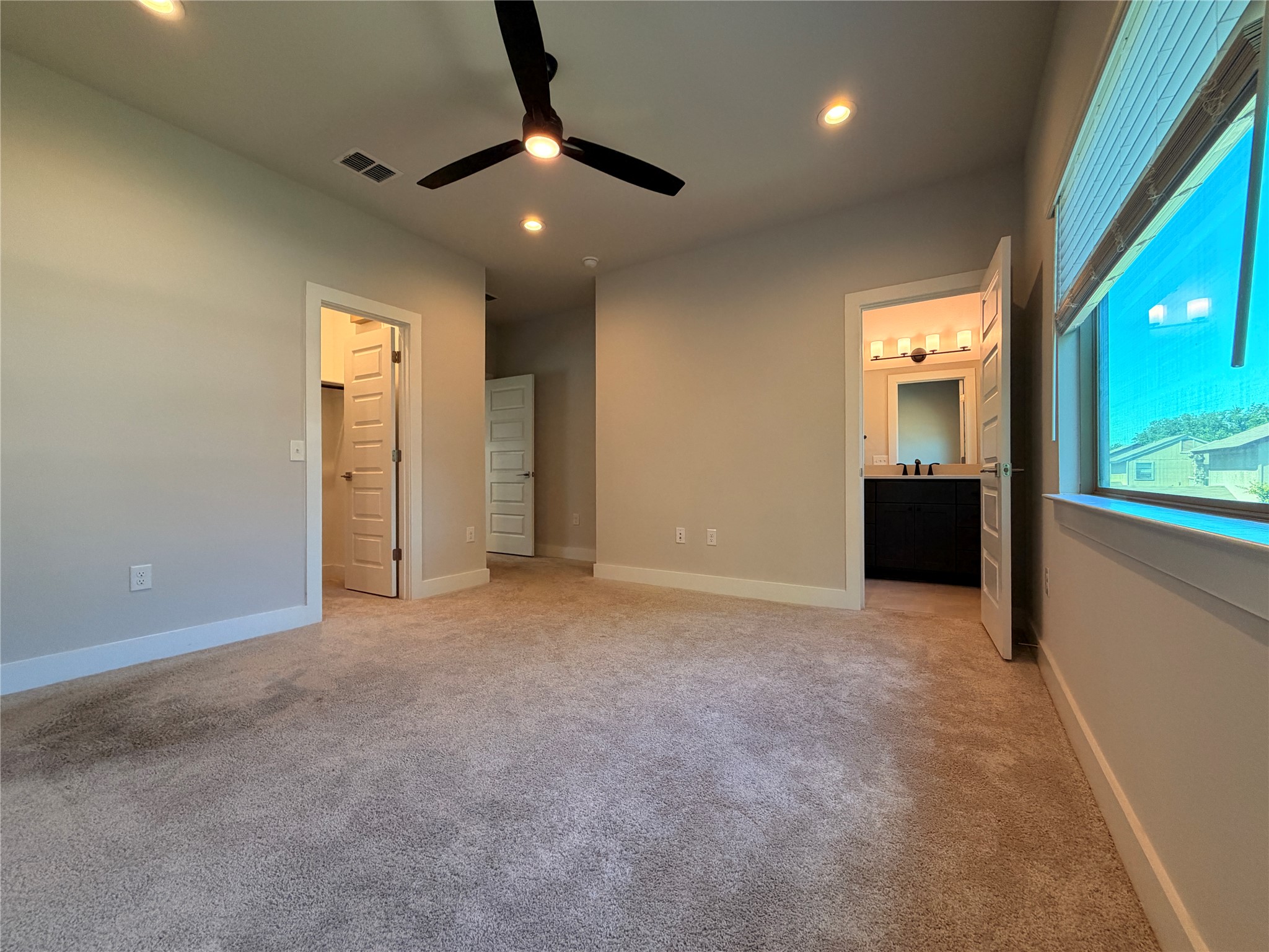 3411 Willow Springs Road, Unit B Austin, TX 78704 - Photo 5 of 8 an empty room with ceiling fan and kitchen view
