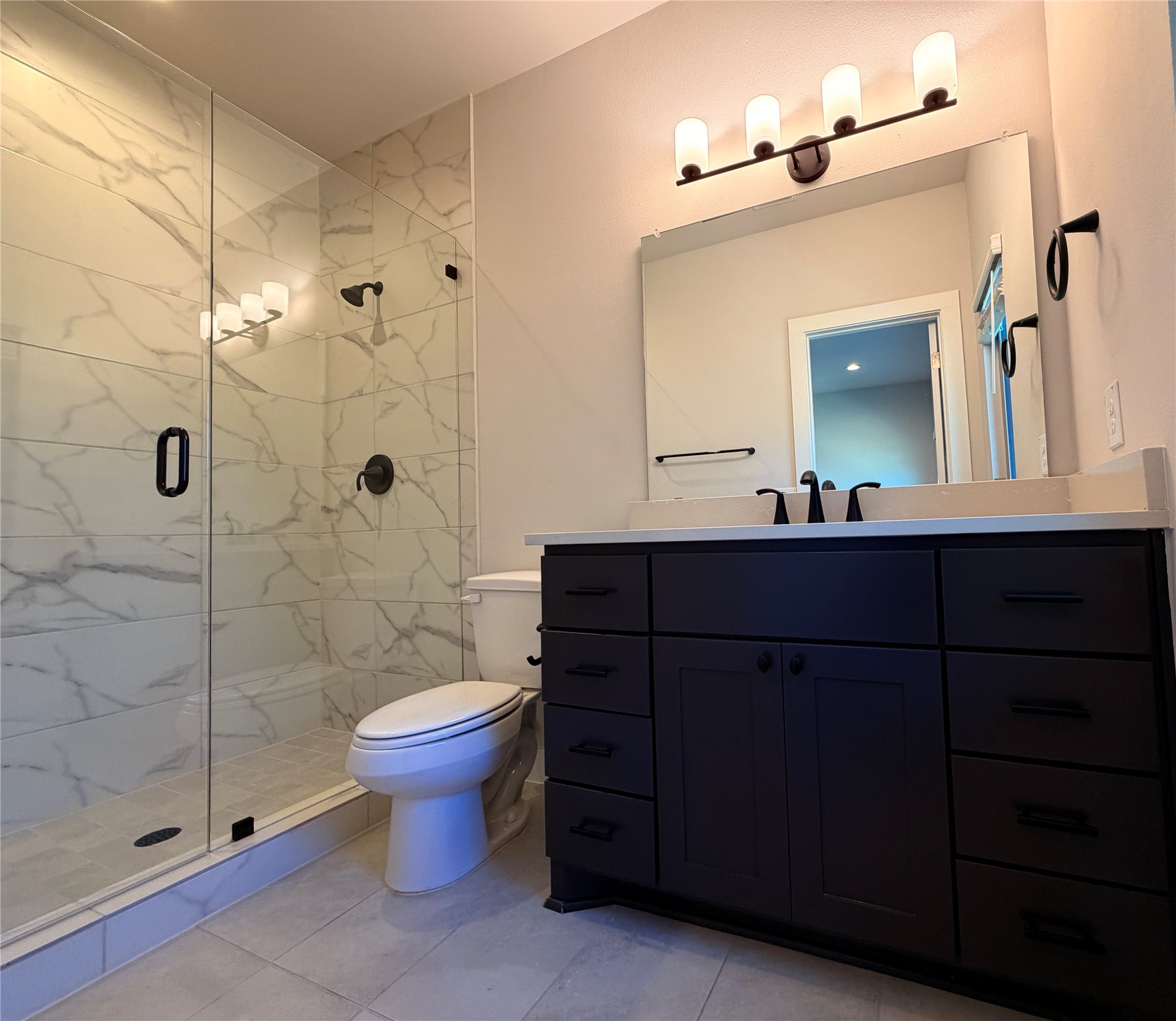3411 Willow Springs Road, Unit B Austin, TX 78704 - Photo 6 of 8 a bathroom with a sink a toilet and shower