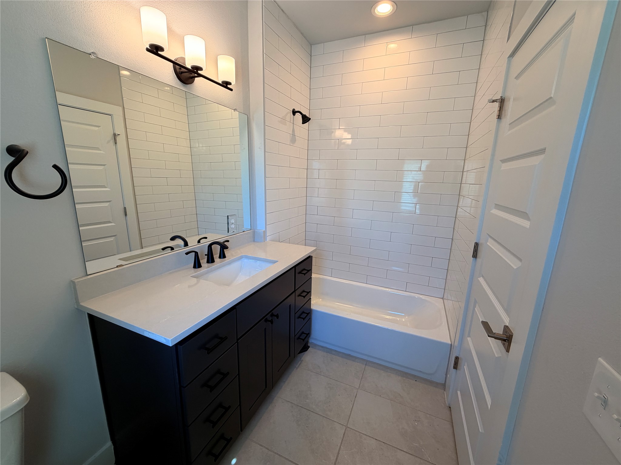 3411 Willow Springs Road, Unit B Austin, TX 78704 - Photo 7 of 8 a bathroom with a sink a tub and a mirror