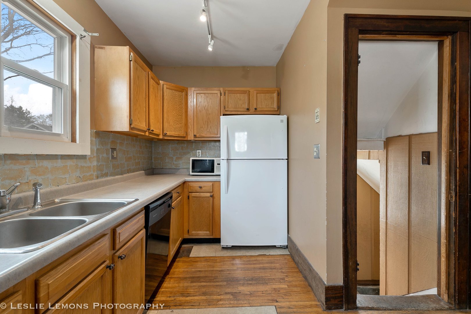 1106 Sycamore Road DeKalb, IL 60115 - Photo 11 of 30 a kitchen with stainless steel appliances granite countertop a refrigerator a sink and a stove