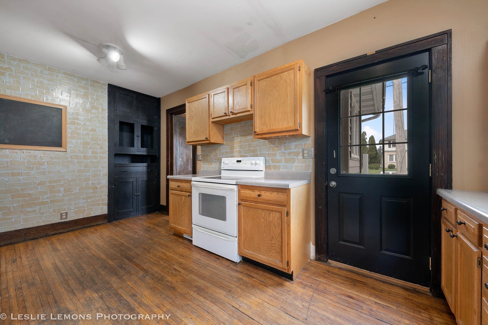 1106 Sycamore Road DeKalb, IL 60115 - Photo 12 of 30 a kitchen with stainless steel appliances granite countertop a stove a sink and a refrigerator