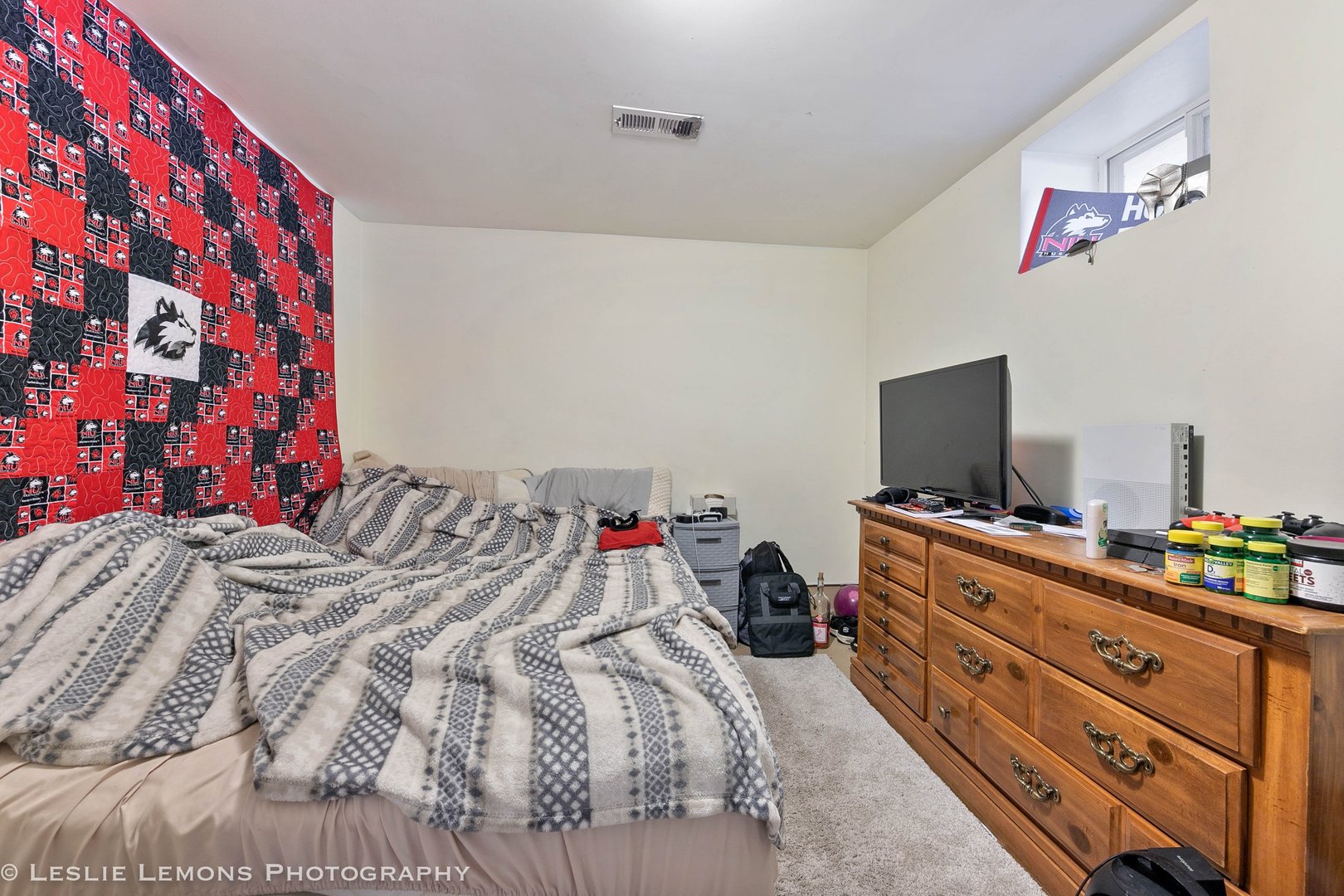 1106 Sycamore Road DeKalb, IL 60115 - Photo 24 of 30 a bedroom with a bed and a flat screen tv