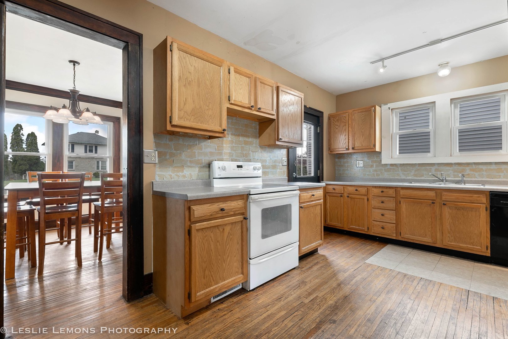 1106 Sycamore Road DeKalb, IL 60115 - Photo 8 of 30 a kitchen with stainless steel appliances granite countertop a stove a sink and a refrigerator
