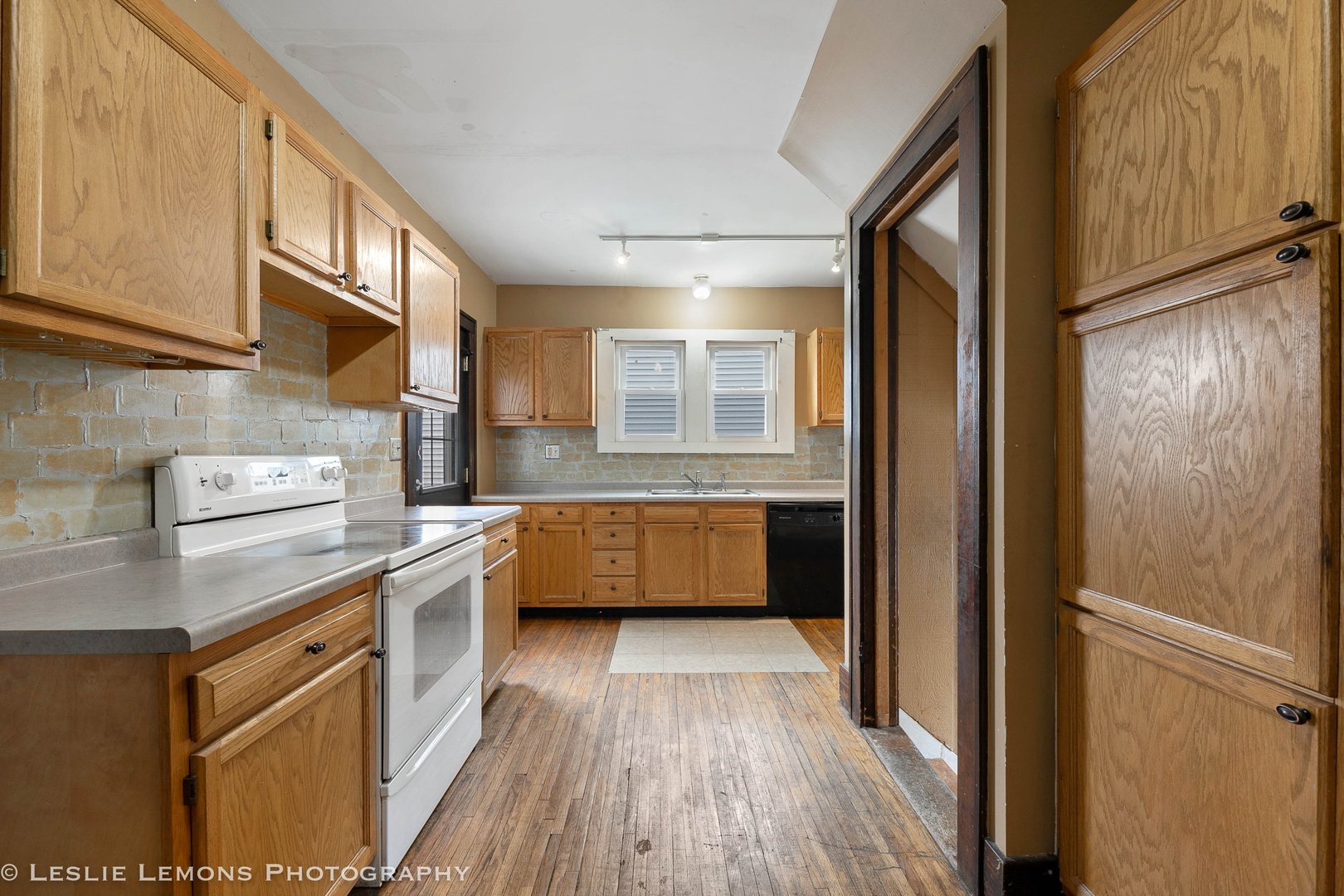 1106 Sycamore Road DeKalb, IL 60115 - Photo 9 of 30 a kitchen with stainless steel appliances granite countertop a refrigerator a sink dishwasher a stove and white countertops with wooden floor