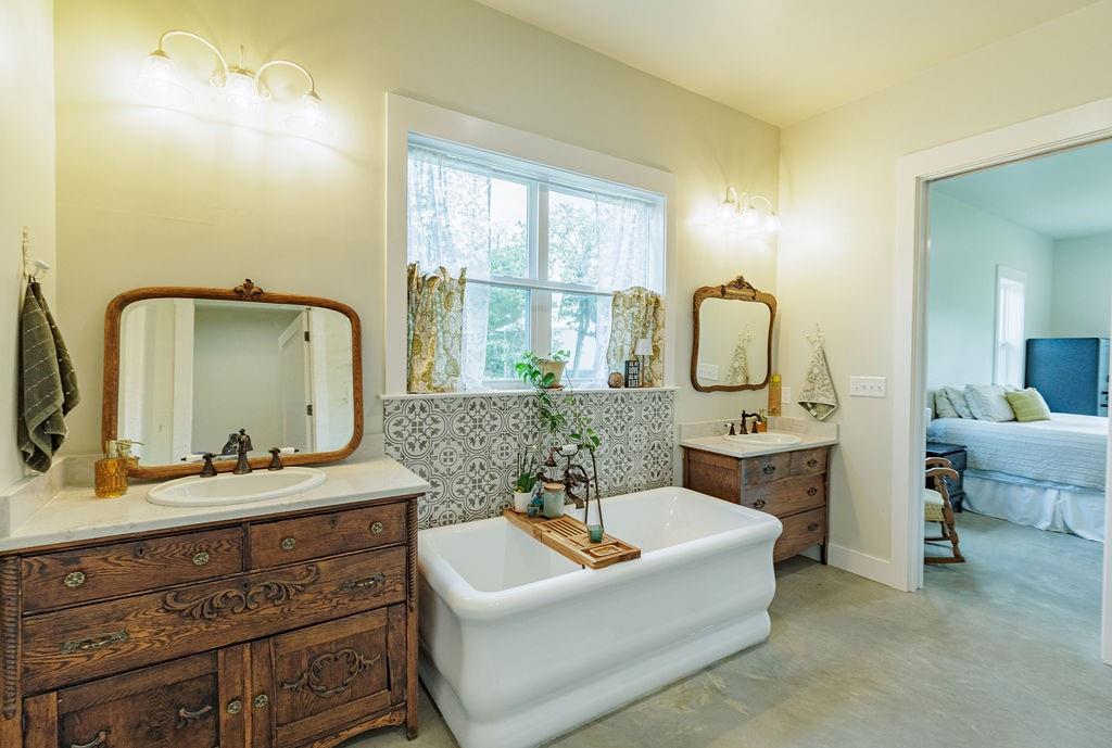 2094 Jim Harry Loop Sunset, TX 76270 - Photo 16 of 40 relaxing primary bathroom with separate vanities, 7 foot soaking tub and notched out make-up space beside shower