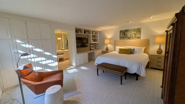 a bedroom with furniture and a large window