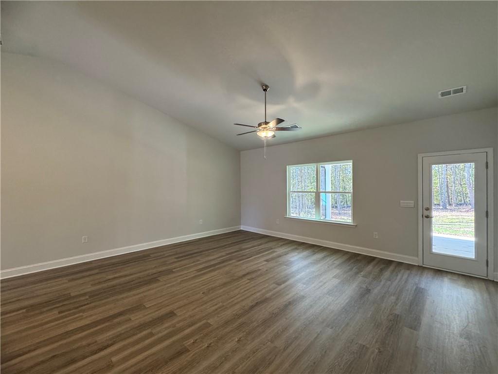 562 Walnut Crk Parkway Pendergrass, GA 30567 - Photo 17 of 20 a view of an empty room with wooden floor and a window