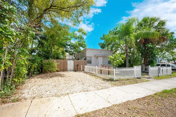 a front view of a house with a wooden fence