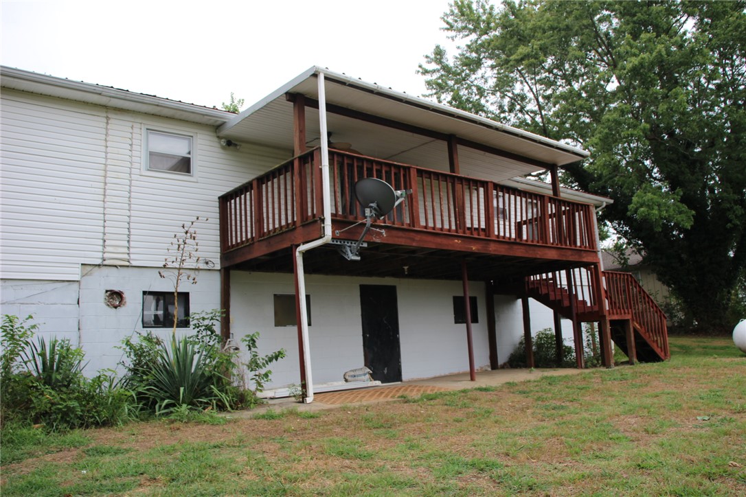 402 Canaan Road Marshall, AR 72650 - Photo 5 of 37 Expansive exterior deck featuring a covered upper level, wood railing, and staircase