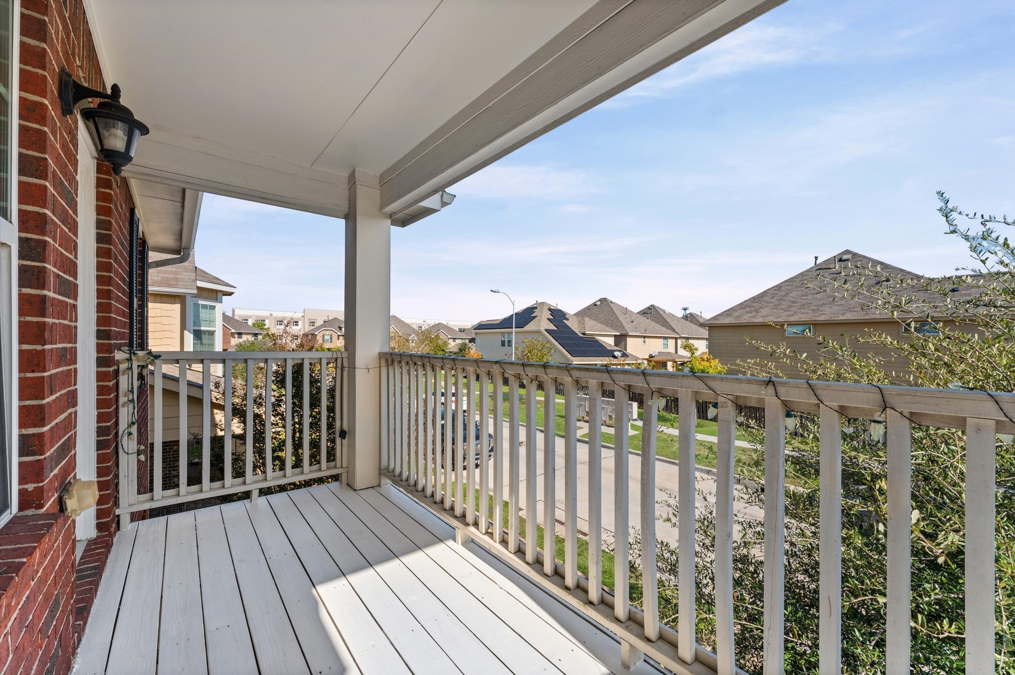 7018 Granite Terrace Lane Houston, TX 77083 - Photo 17 of 18 a view of a balcony with wooden floor and fence