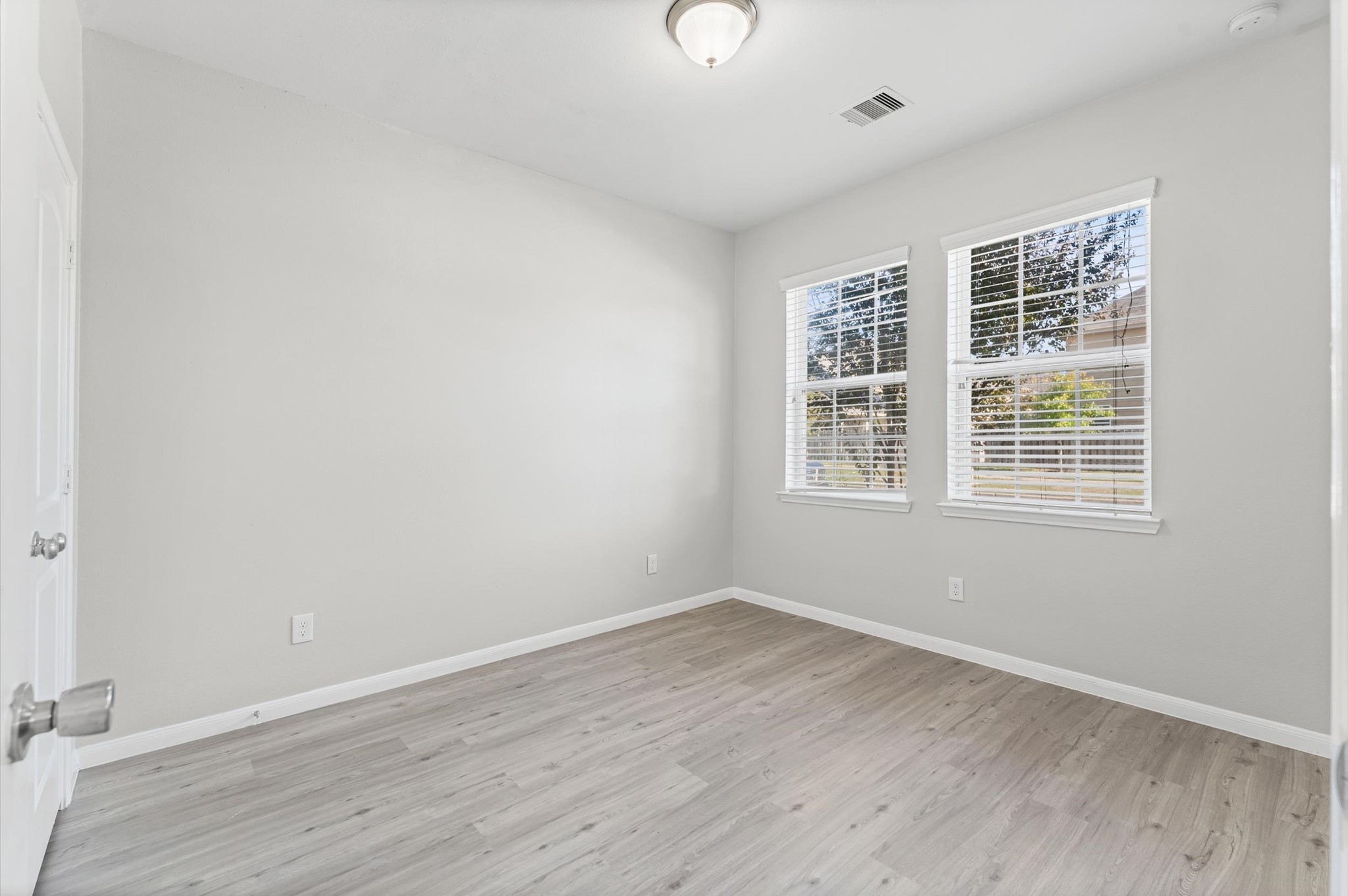 7018 Granite Terrace Lane Houston, TX 77083 - Photo 7 of 18 wooden floor in an empty room with a window