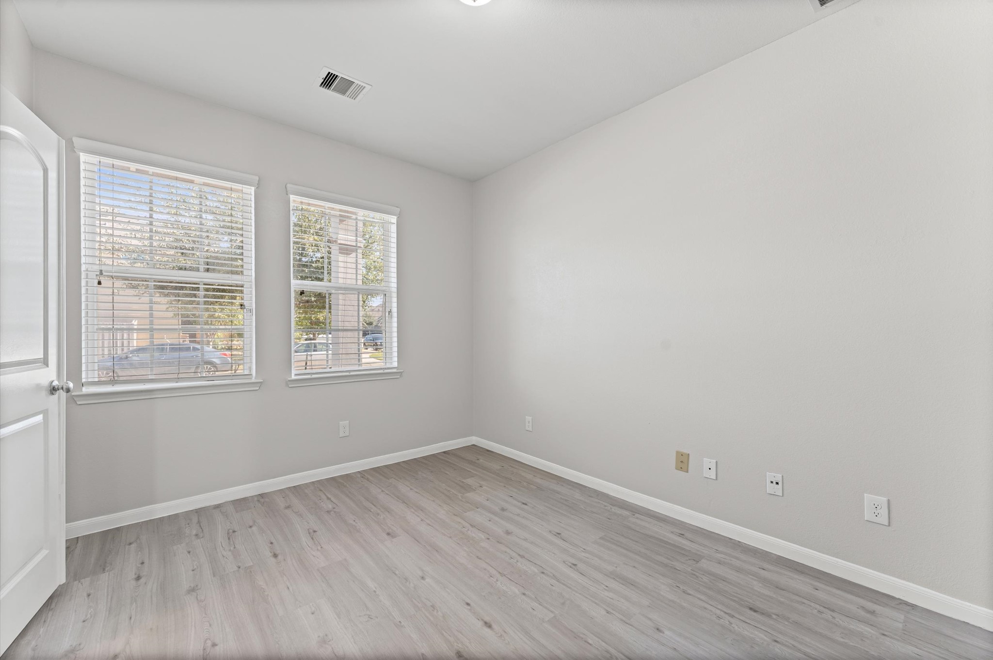 7018 Granite Terrace Lane Houston, TX 77083 - Photo 8 of 18 wooden floor in an empty room with a window