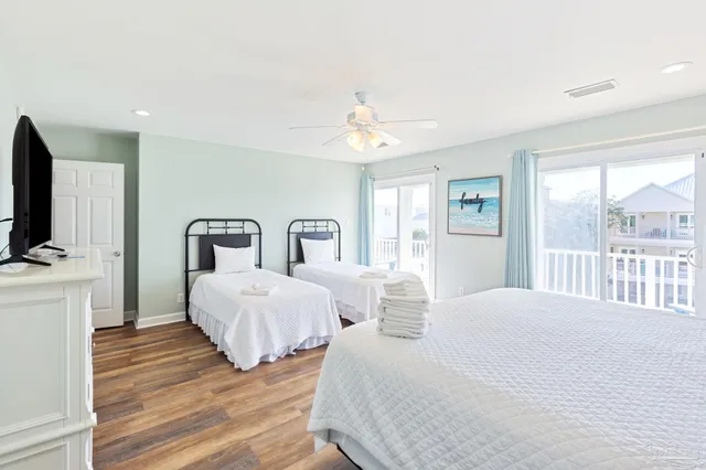 a bedroom with a bed chandelier and a window
