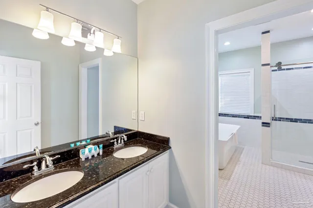 a living room with furniture and a view of kitchen