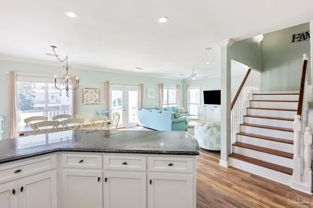 a view of a dining room with furniture wooden floor and chandelier