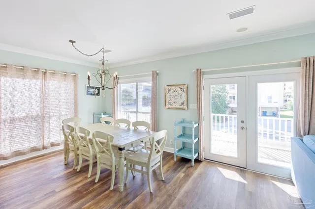 a living room with furniture kitchen view and a flat screen tv