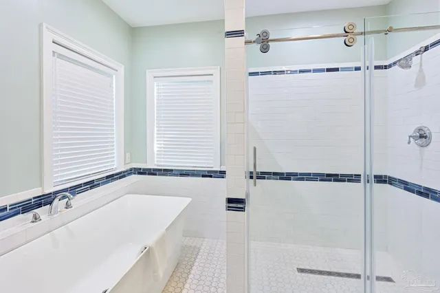 a bathroom with a shower and a glass door