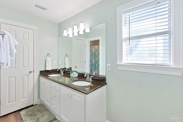 a bathroom with a toilet a sink and a mirror