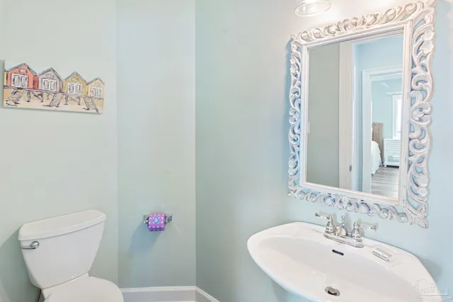 a bathroom with a double vanity sink toilet and a mirror
