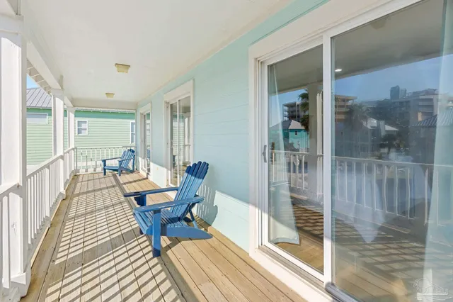 a balcony with chairs and table