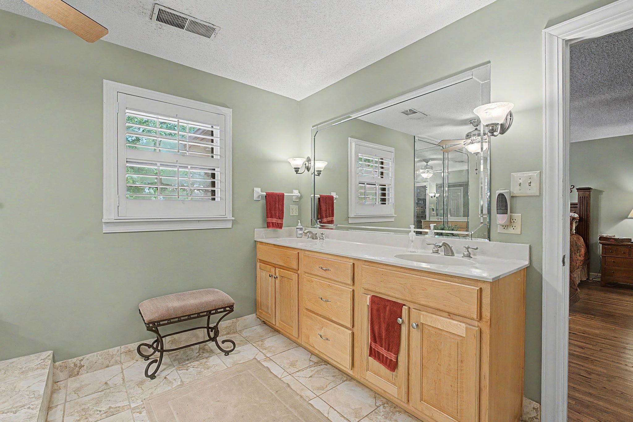 1929 Miller Farms Road Germantown, TN 38138 - Photo 24 of 40 Double vanity with integrated sinks, light wood cabinetry, and a full-width mirror