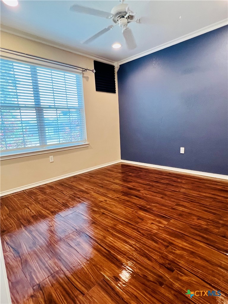 8210 Sunset Trail Temple, TX 76502 - Photo 6 of 15 an empty room with wooden floor and windows