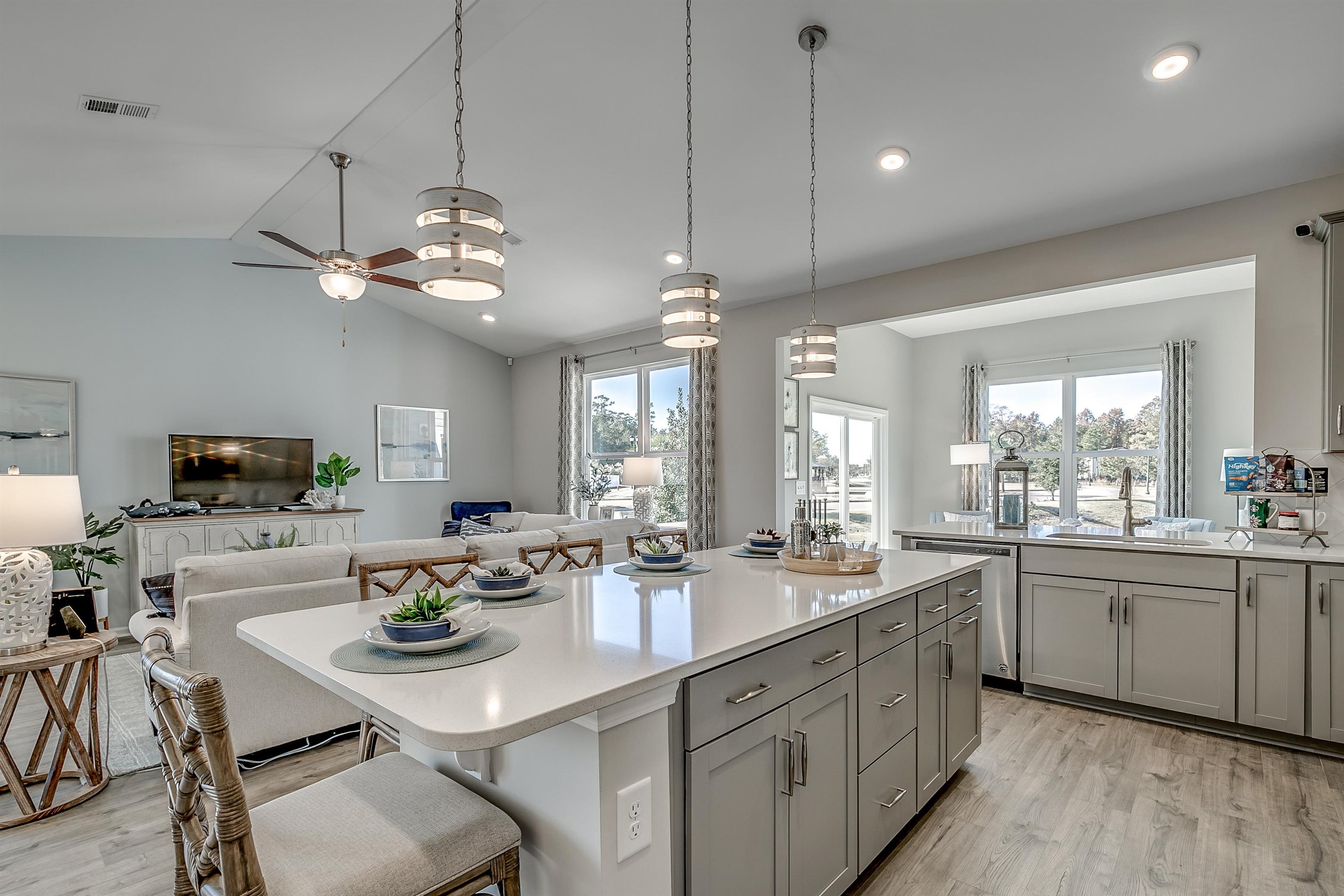 583 Kapalua Loop Little River, SC 29566 - Photo 15 of 15 Kitchen featuring a breakfast bar area, open floor plan, light wood finished floors, a kitchen island, and vaulted ceiling