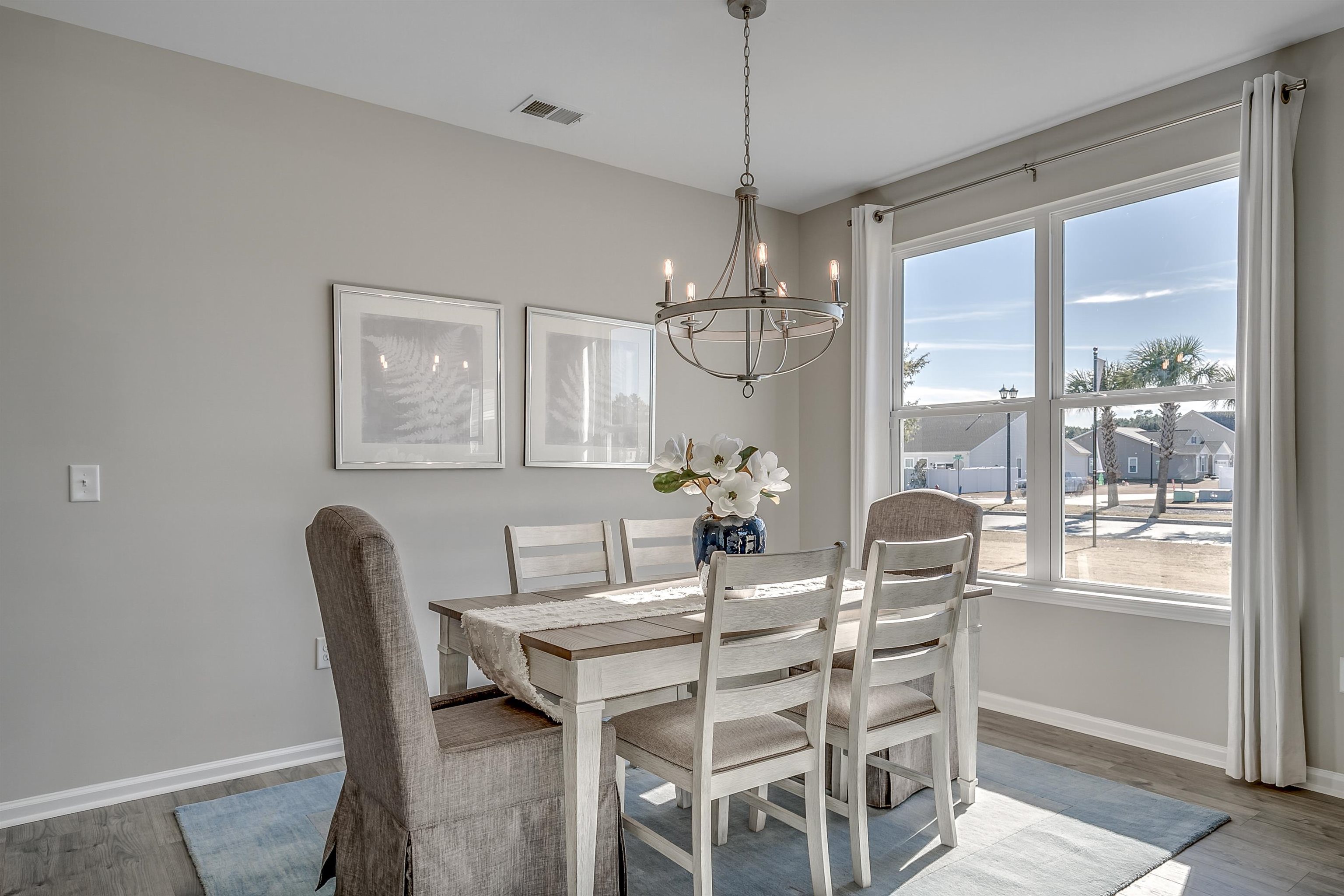 583 Kapalua Loop Little River, SC 29566 - Photo 4 of 15 Dining area with wood finished floors and a chandelier