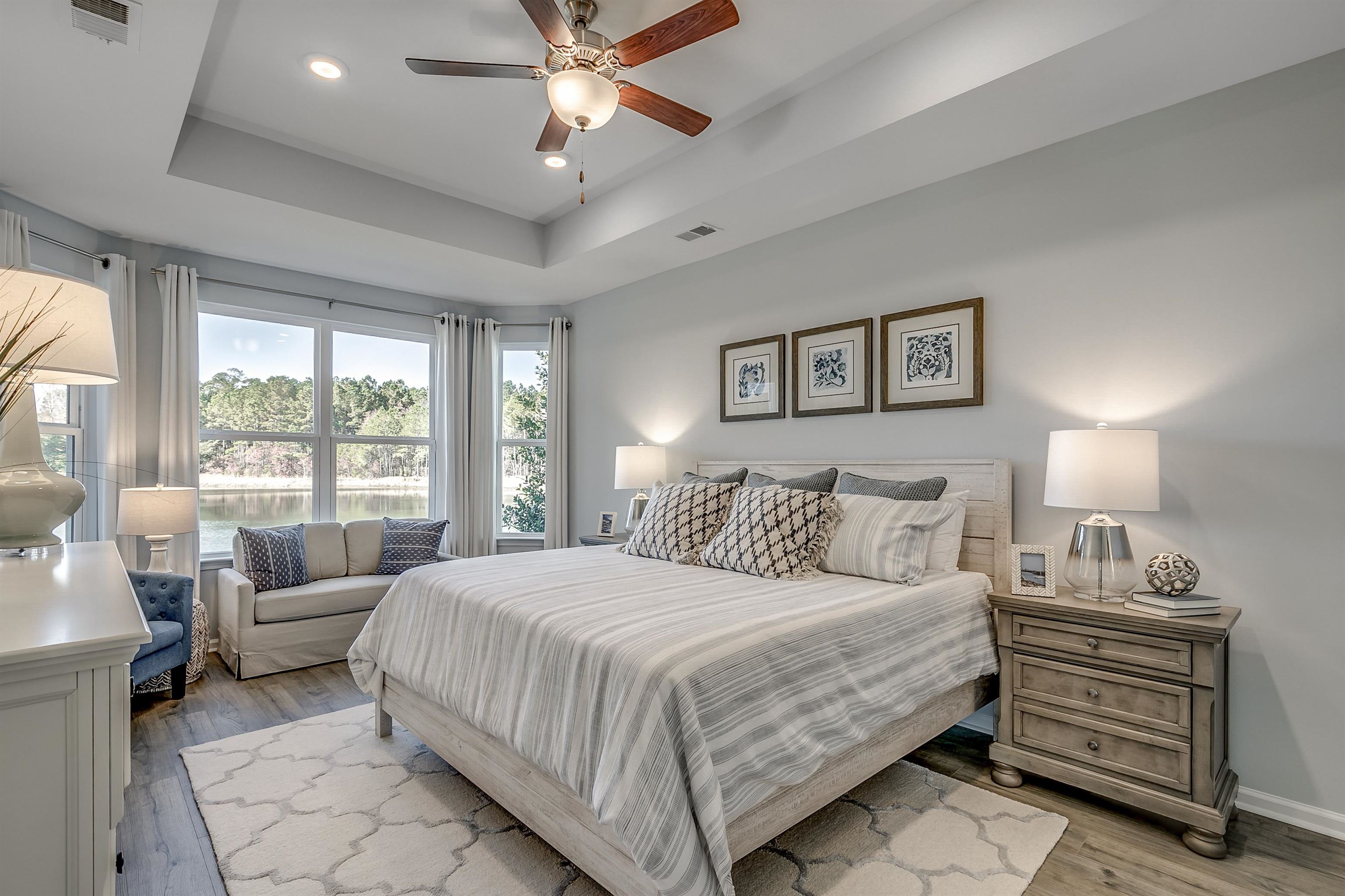 583 Kapalua Loop Little River, SC 29566 - Photo 5 of 15 Bedroom featuring wood finished floors, recessed lighting, ceiling fan, a water view, and a tray ceiling