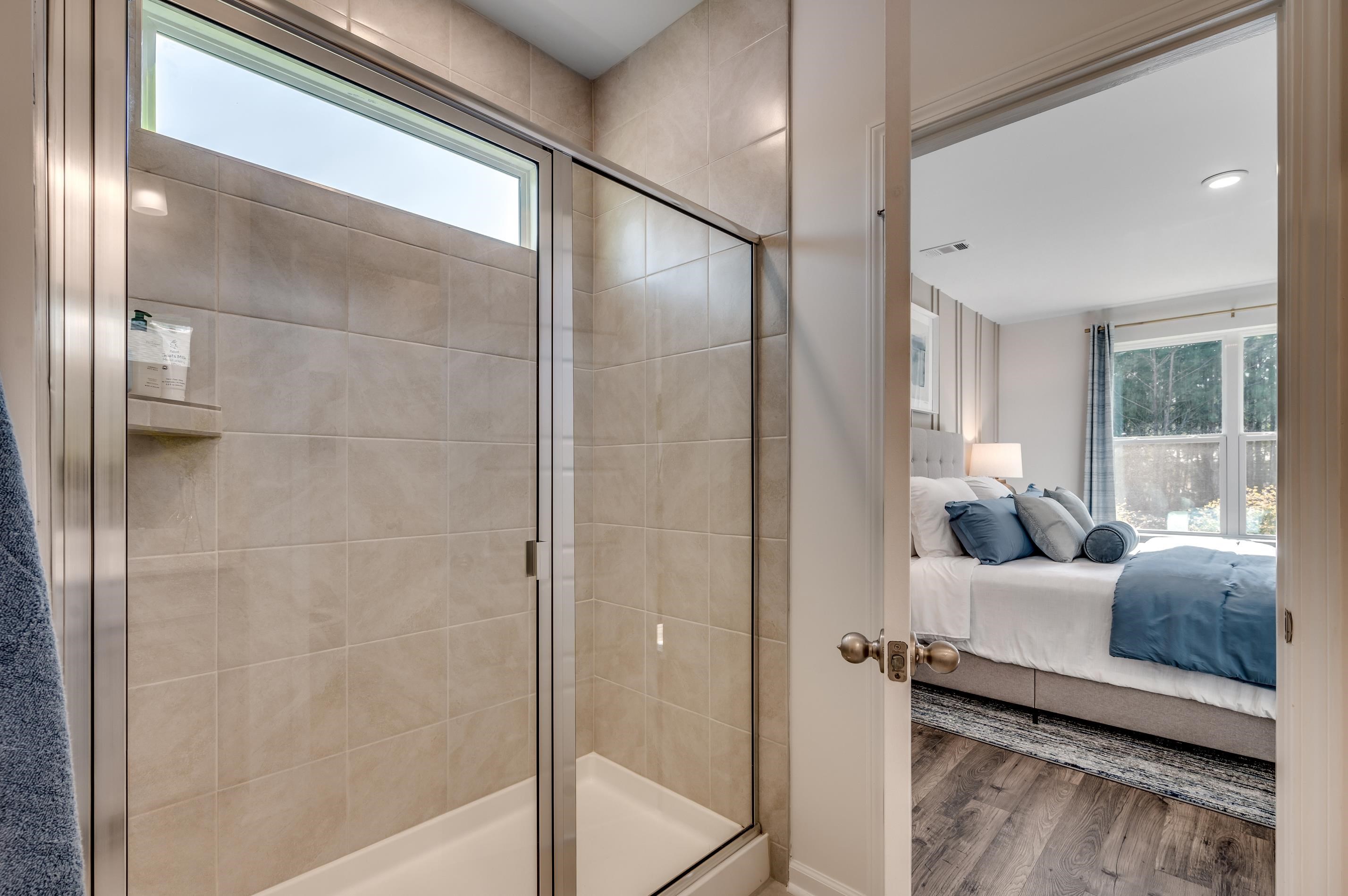 583 Kapalua Loop Little River, SC 29566 - Photo 6 of 15 Ensuite bathroom featuring plenty of natural light, a shower stall, and wood finished floors