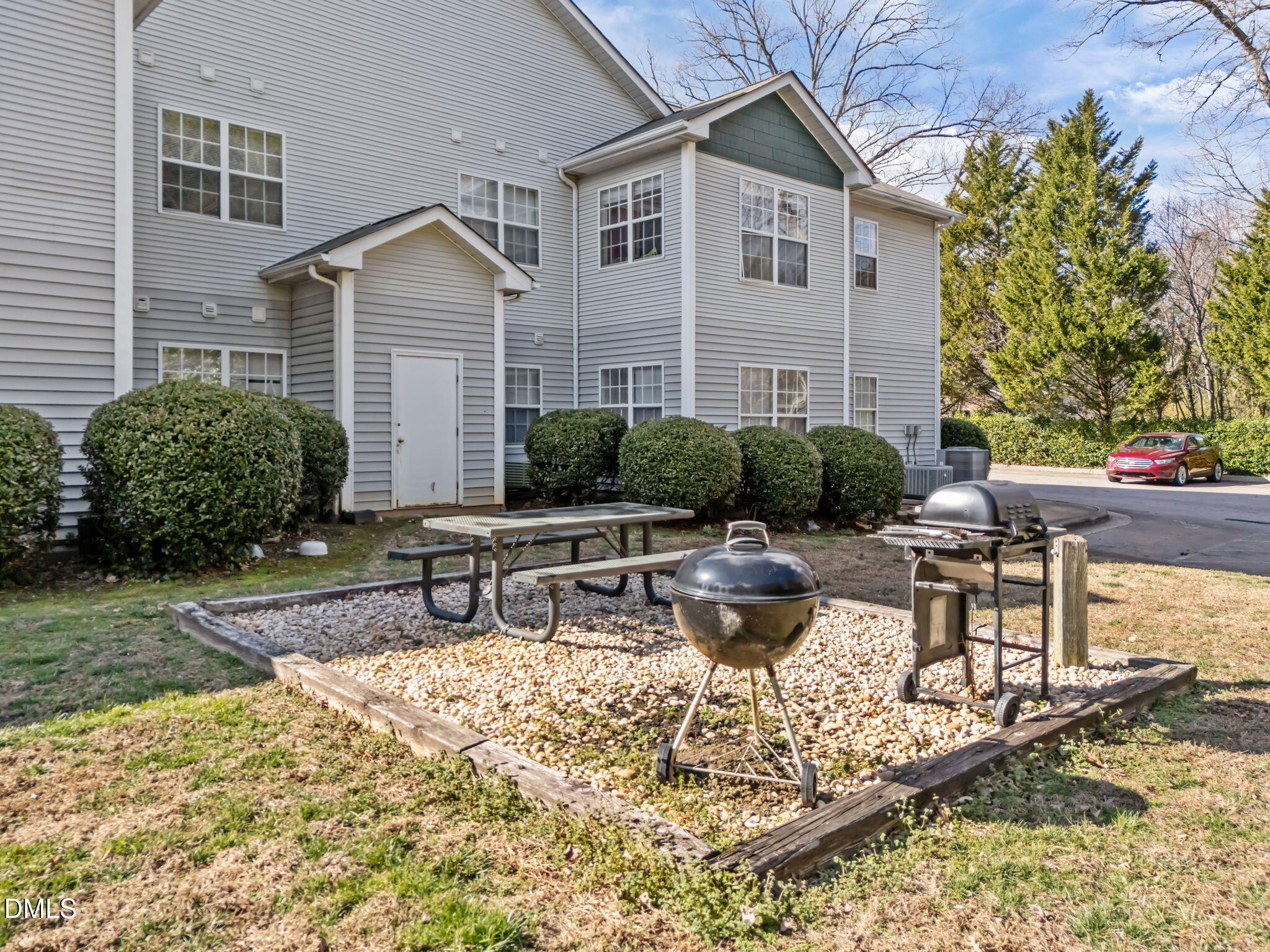 1305 Kent Road, Unit 101 Raleigh, NC 27606 - Photo 22 of 29 a view of a house with backyard water fountain and sitting area