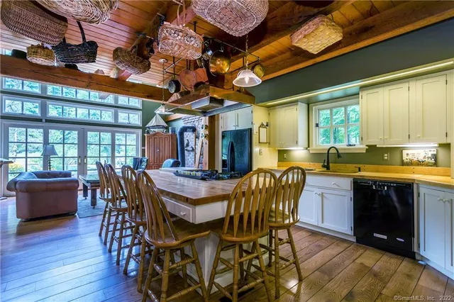 a living room with furniture fireplace and wooden floor