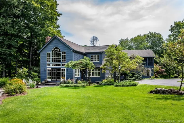 a view of a house with a yard porch and sitting area
