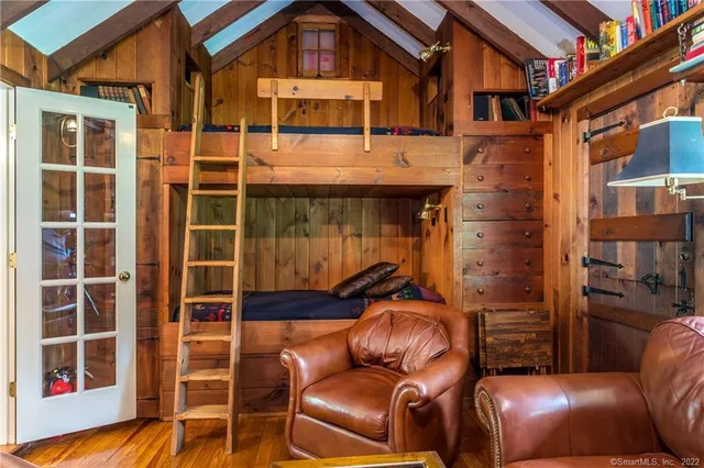 a bedroom with a bed and large window