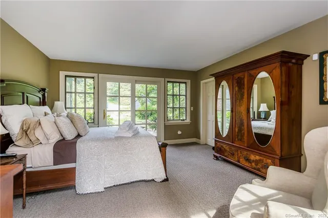 a bath room with a bed and a sink