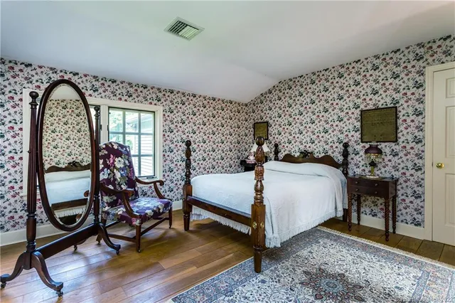 a bathroom with a sink and a wooden floor