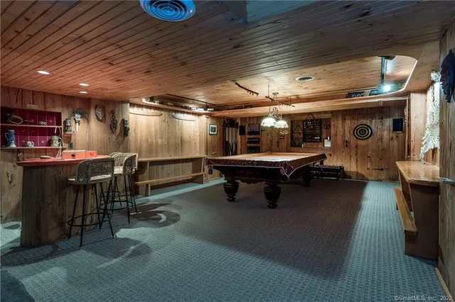 a room with table chairs and wooden floor