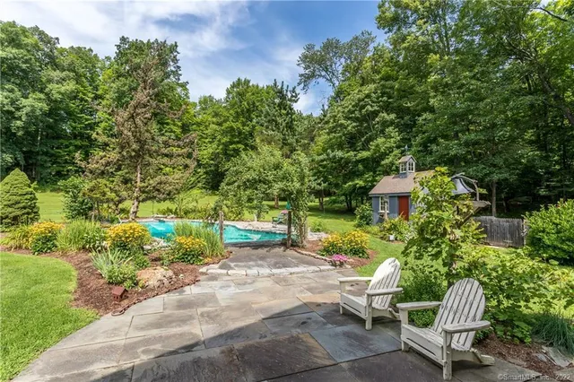 a view of a chair and table in the garden