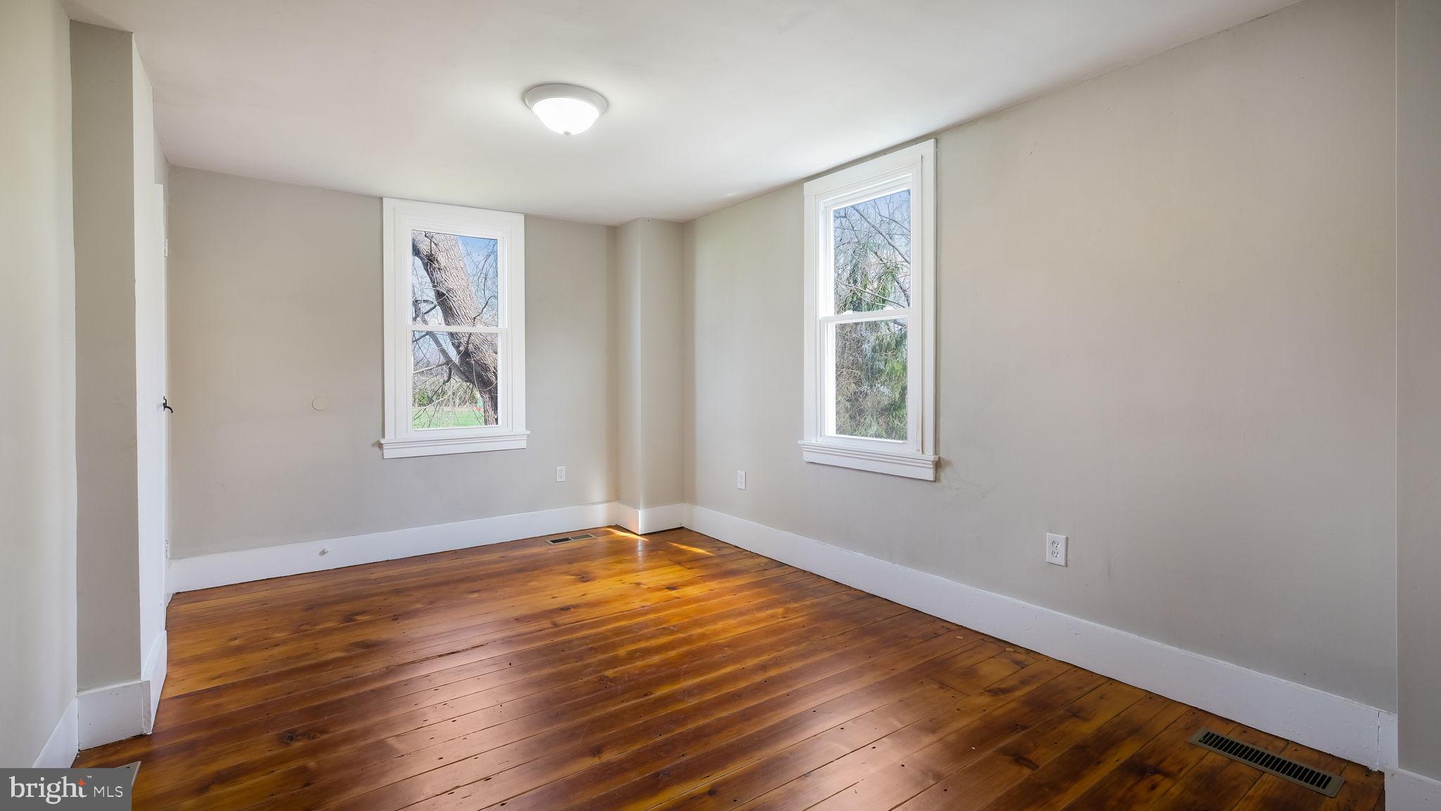 5182 Point Pleasant Pike Doylestown, PA 18902 - Photo 14 of 35 a view of an empty room with window and wooden floor