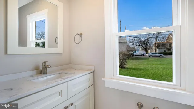 a bathroom with a sink and a window