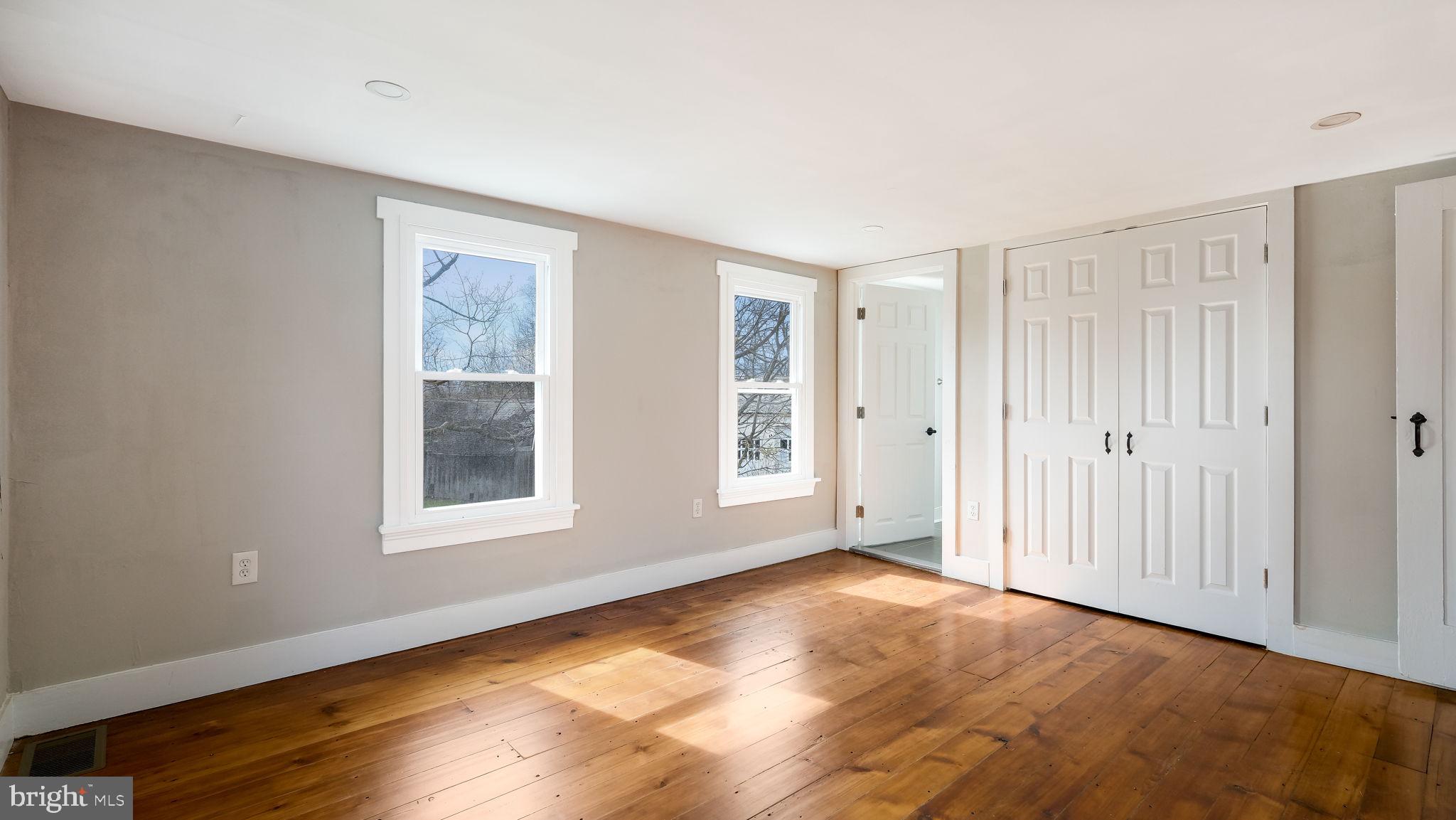 5182 Point Pleasant Pike Doylestown, PA 18902 - Photo 19 of 35 a view of an empty room with wooden floor and a window