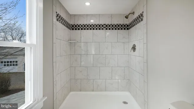 a bathroom with a shower and a bathtub
