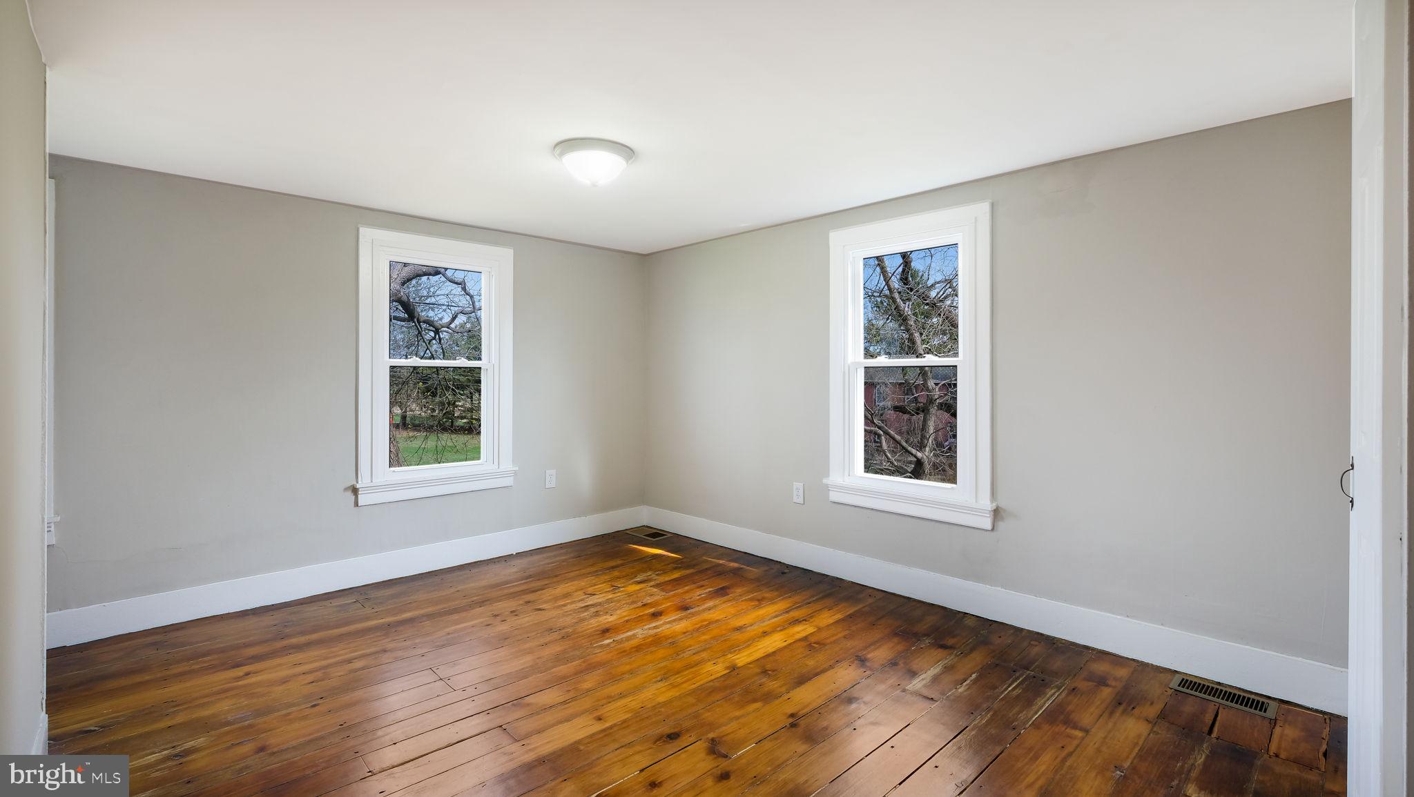 5182 Point Pleasant Pike Doylestown, PA 18902 - Photo 22 of 35 wooden floor in an empty room with a window