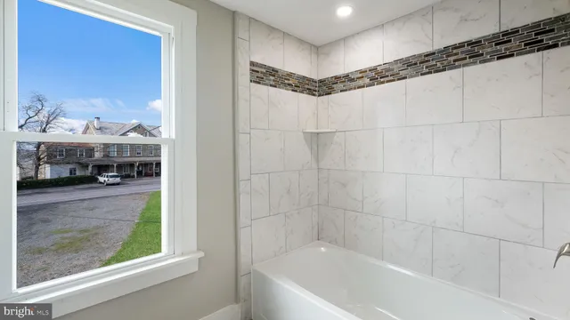 a bathroom with a tub and a shower
